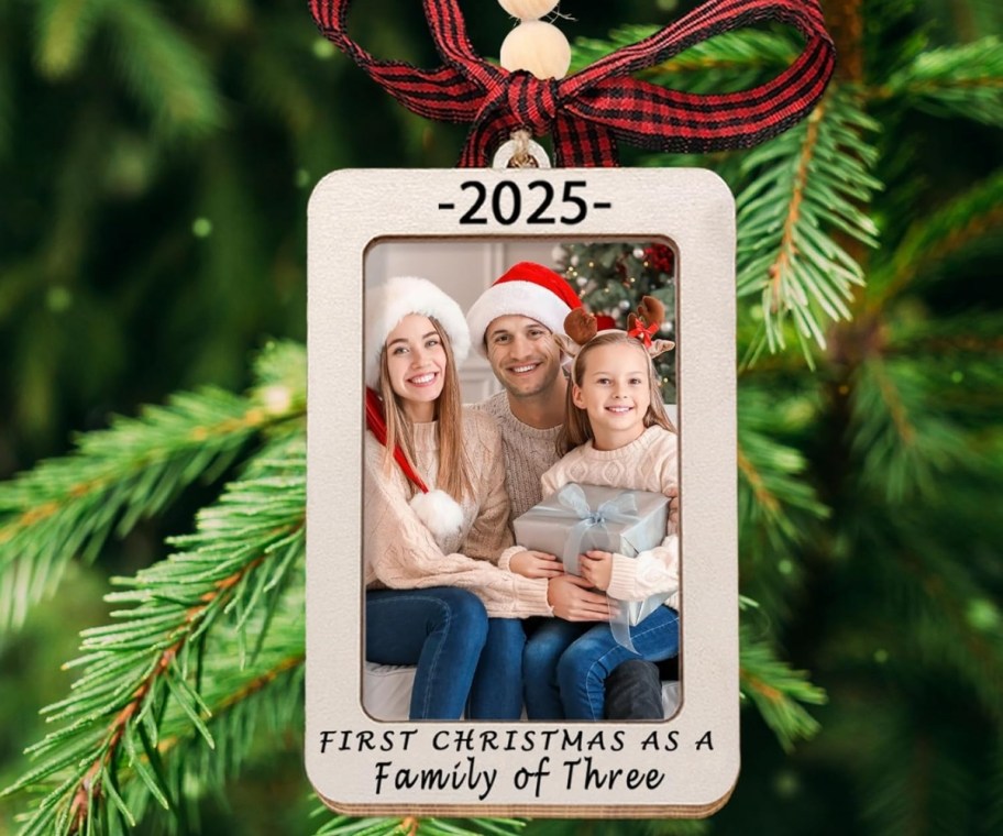 a photo of a family of 3 wearing santa hats