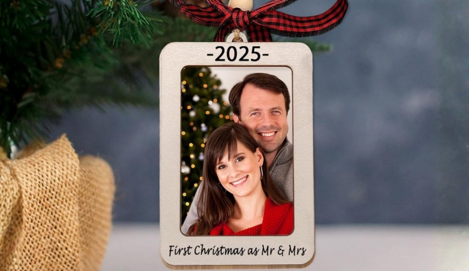 newly married couple in a wooden ornament frame