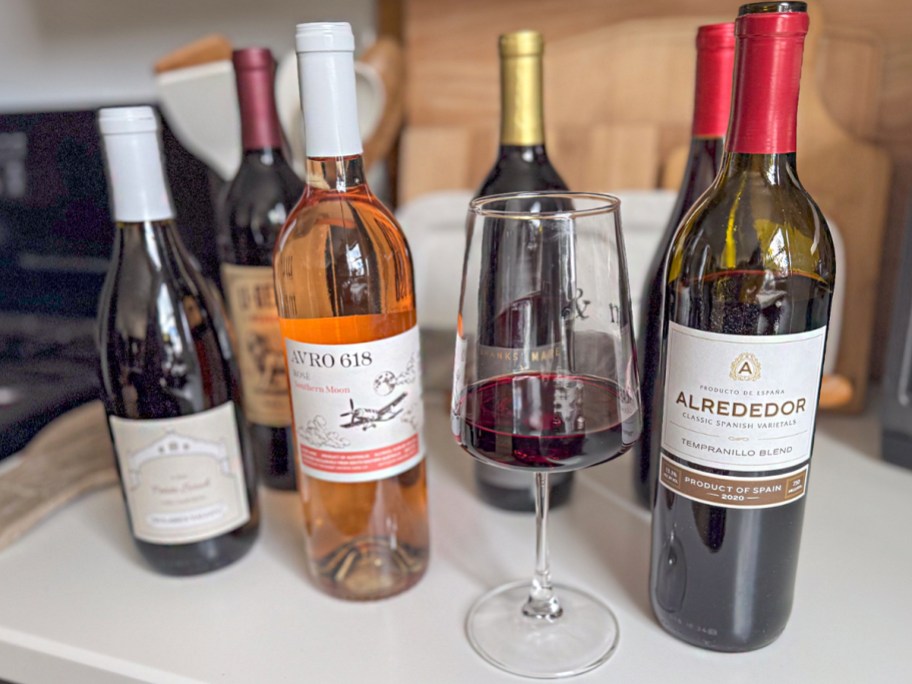 wine bottles with glass on counter