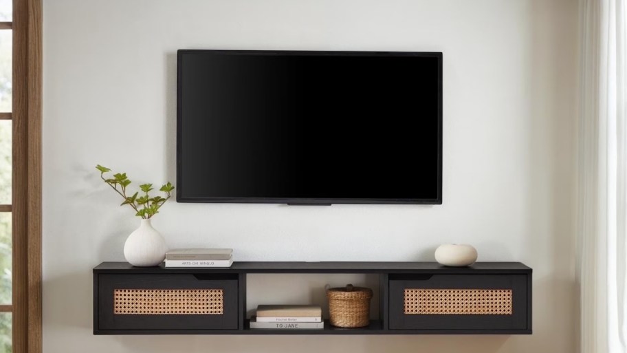 a floating tv console mounted on a wall