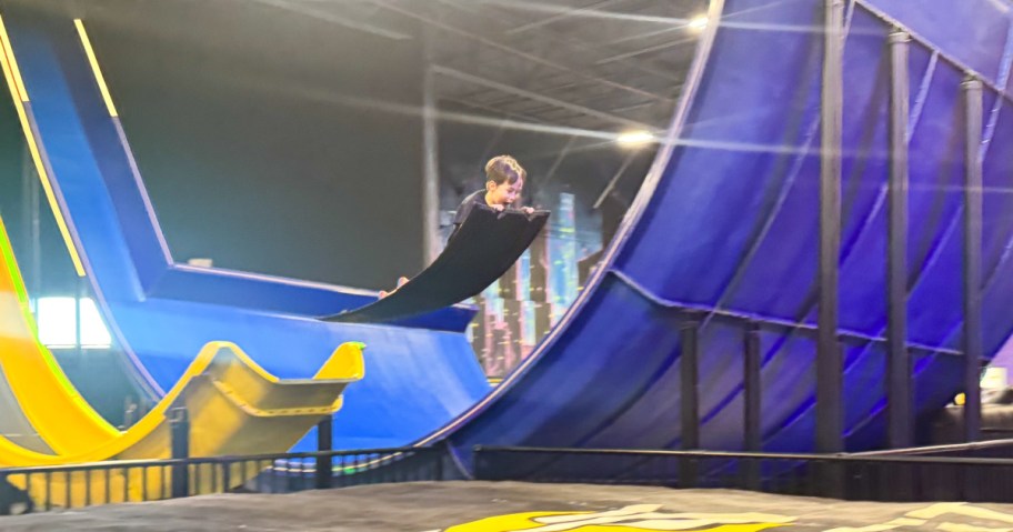 boy flying through the air at slick city