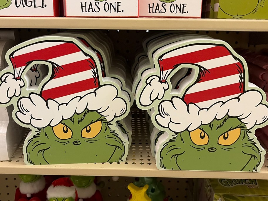 grinch wood decor with santa hat 