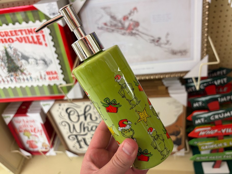 hand holding grinch hand soap dispenser 