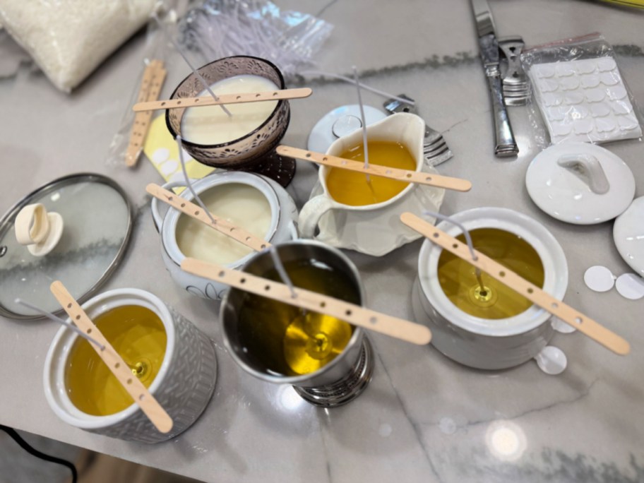 group of homemade candles using thrift store vessels