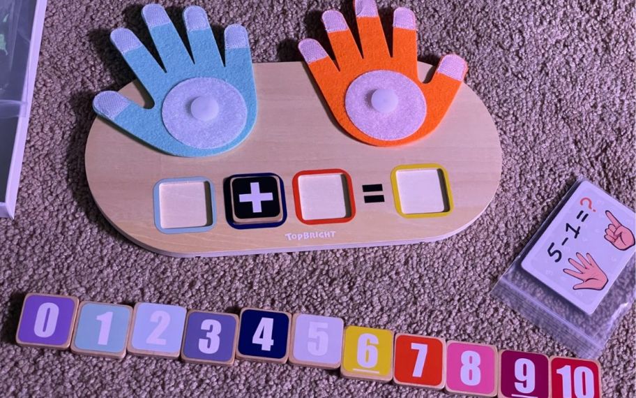 hand learning toy with blocks and numbers shown