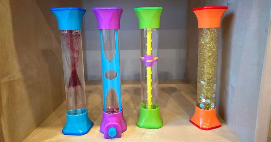four sensory tubes on shelf