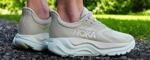 person wearing light green hoka shoes