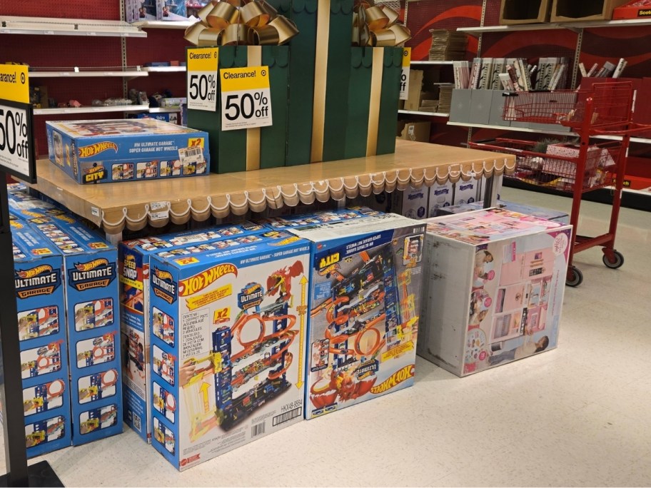 hotwheels track and barbie dream house in a store aisle