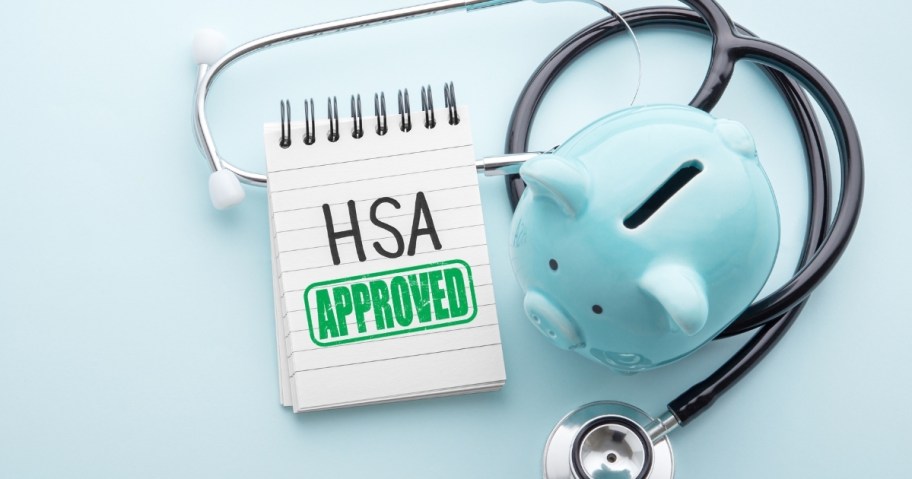 hsa approved on notepad with blue piggy bank