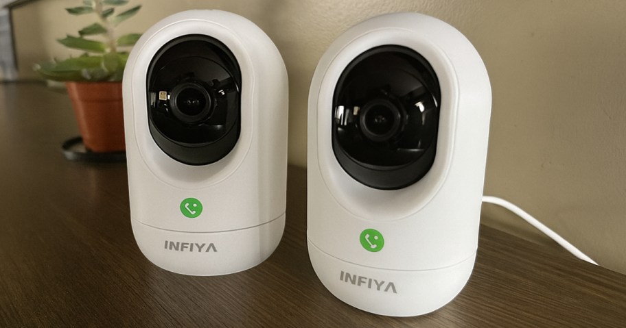 two security cameras on a shelf