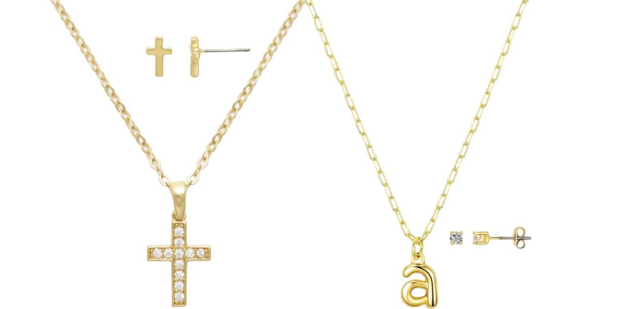 Gold jewelry set featuring two necklaces and earrings. One necklace has a cross pendant with gems; the other has a lowercase "a" pendant. Matching stud earrings included.