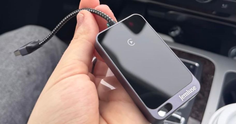 Hand Holding a Jemluse Wireless Carplay Adapter