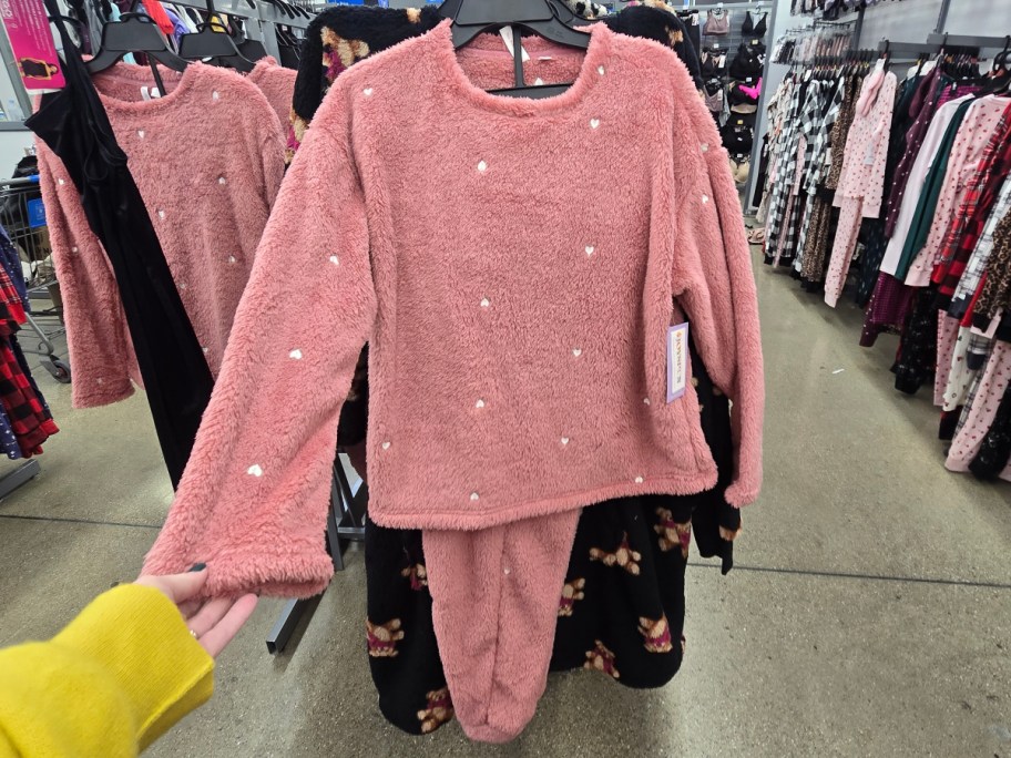 pink pajamas hanging on rack at Walmart