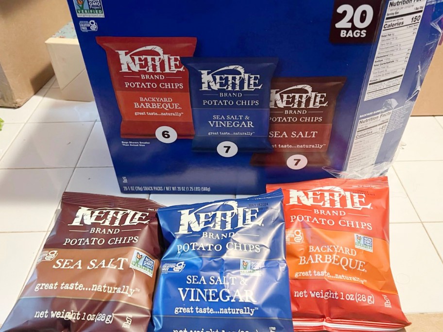 kettle chips box with three bags laying in front of it