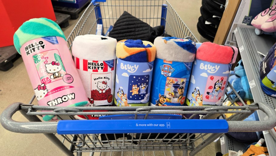 kids character throw blankets rolled & lined up in a store cart