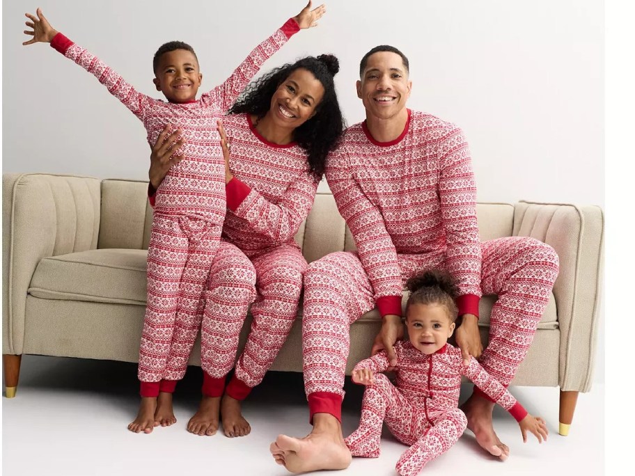 A family wearing Valentine's Day pajamas.