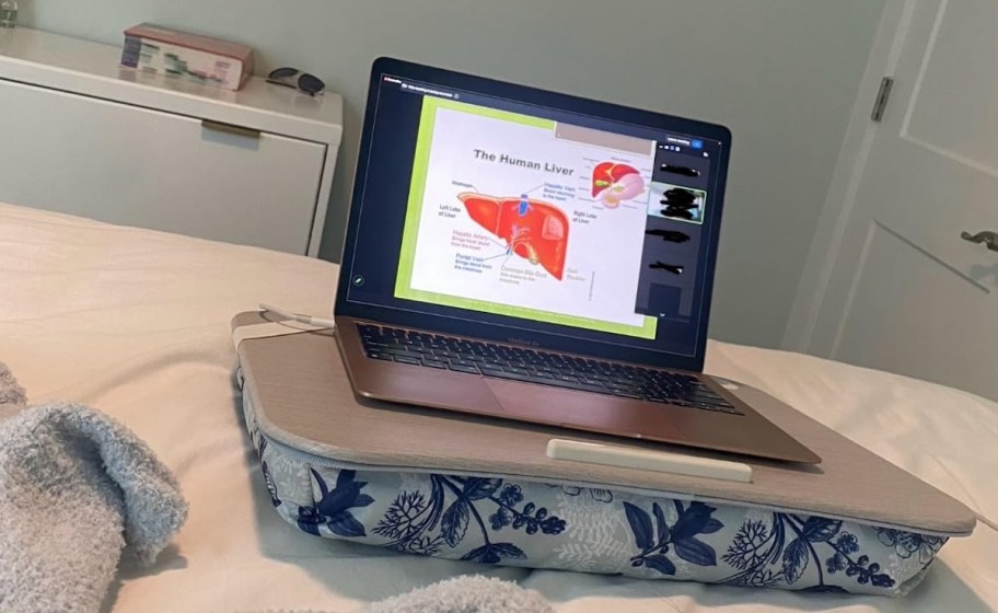 lap desk with laptop on bed