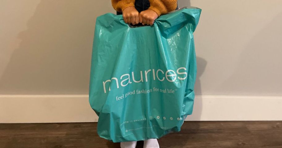 person holding maurices shopping bag