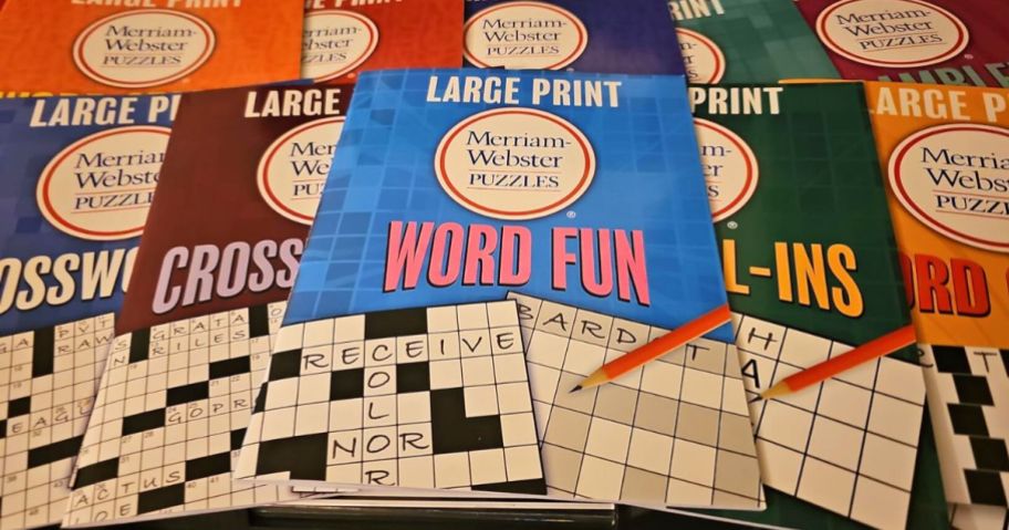 a stack of merriam-webster puzzle books