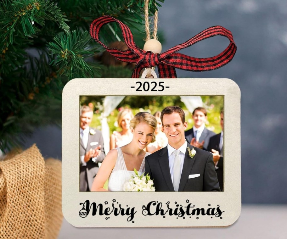 a photo of a newly married couple in a wooden ornament frame