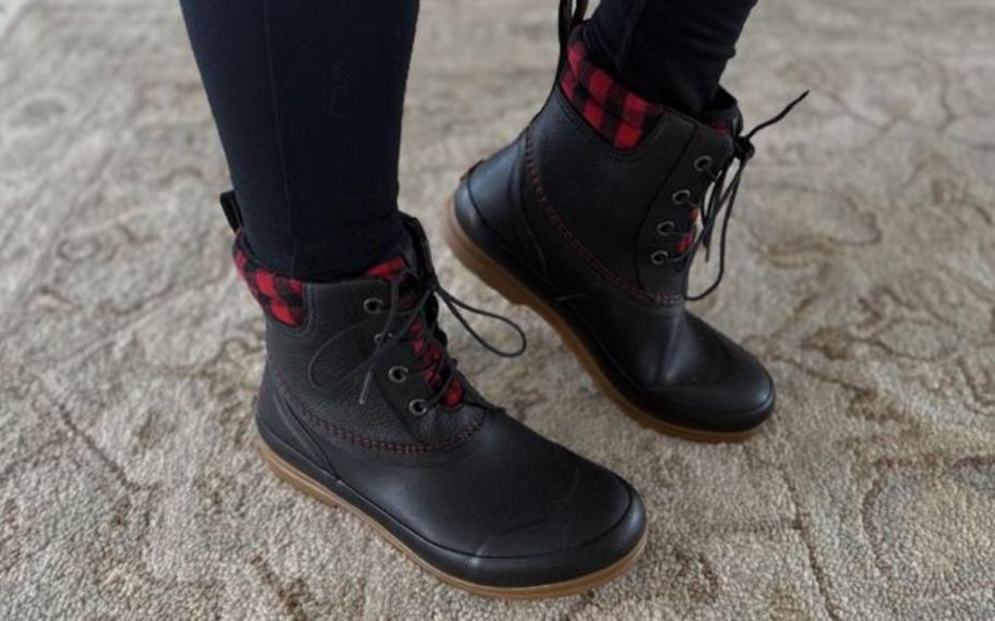 woman wearing muck boots on carpet