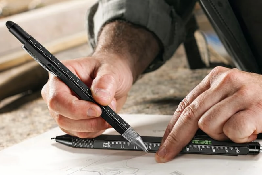 person holding multi-tool pen