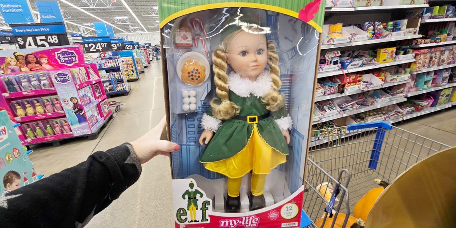 hand holding elf blonde doll in box 