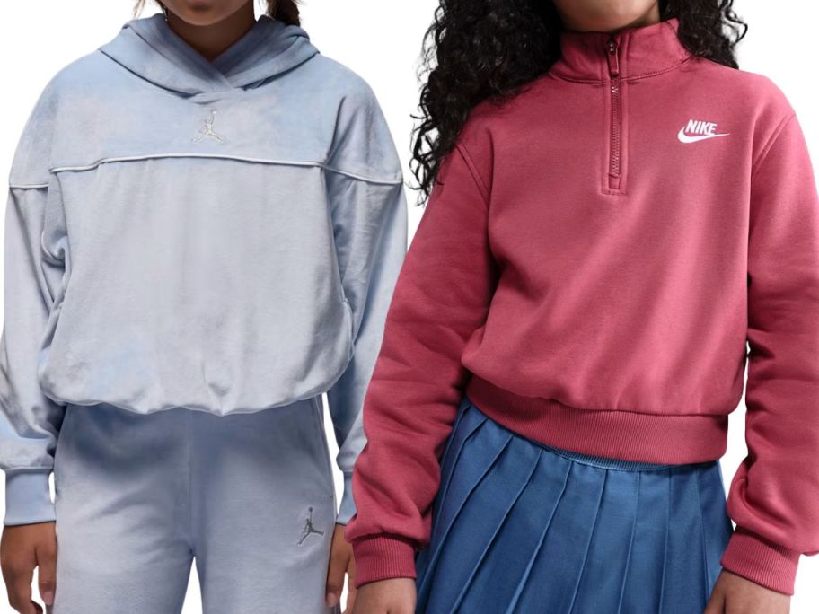 two kids wearing nike hoodies