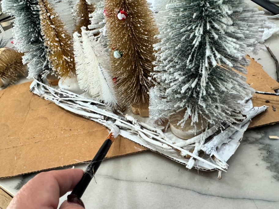 painting the vines white on a centerpiece 