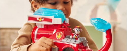 boy playing with a paw patrol fire truck