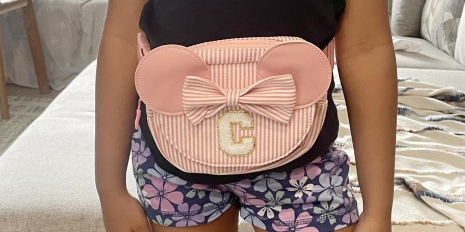 girl wearing pink and white striped bag