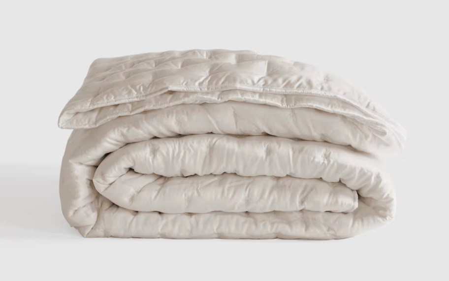 stock photo of cream colored quilt