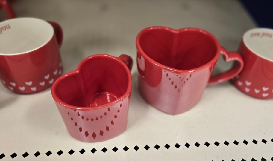 two red heart shaped coffee mugs