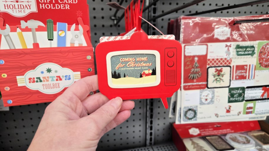 hand holding a gift card holder shaped like a retro tv