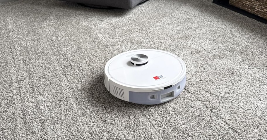 white robot vacuum on carpet