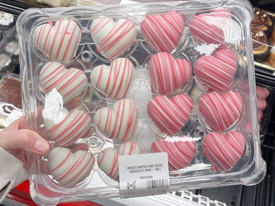 hand holding pink and white heart cake bites box
