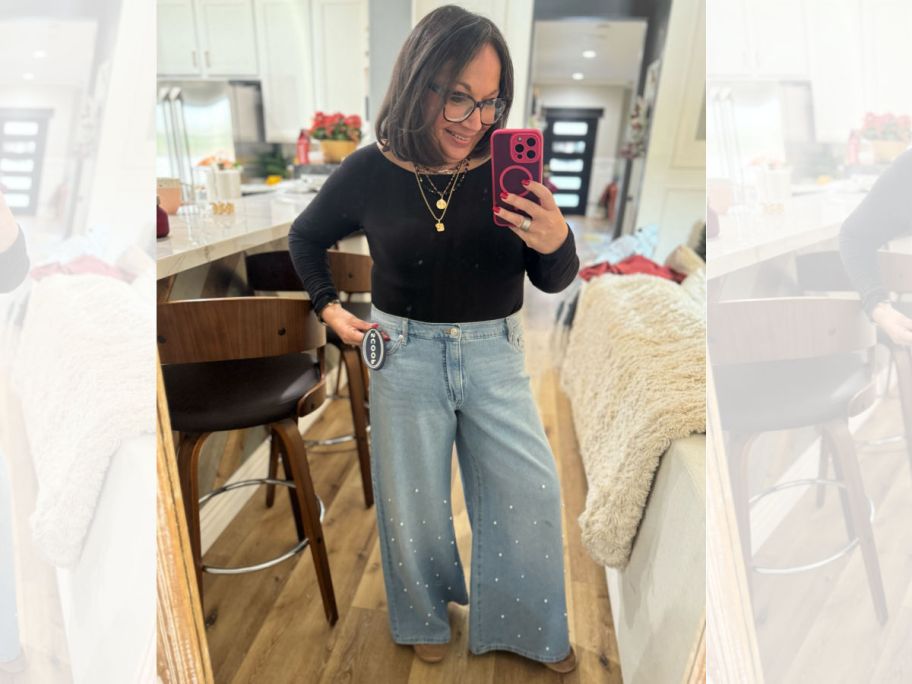 woman in black shirt taking selfie