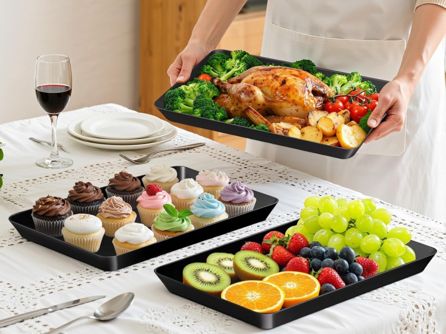 Multiple serving trays with various food items on them.