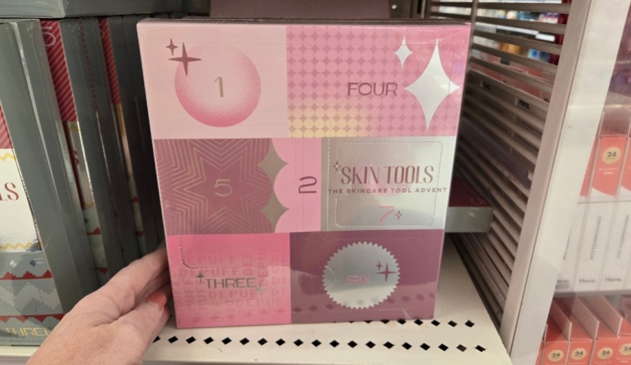womans hand holding a advent calendar skin tools gift set