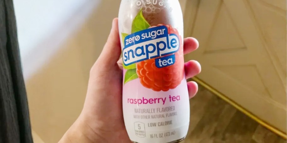 hand holding snapple raspberry tea bottle 