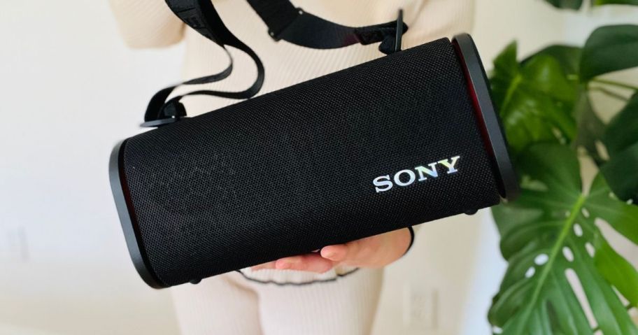 woman holding Sony ULT FIELD 5 Wireless Portable Speaker