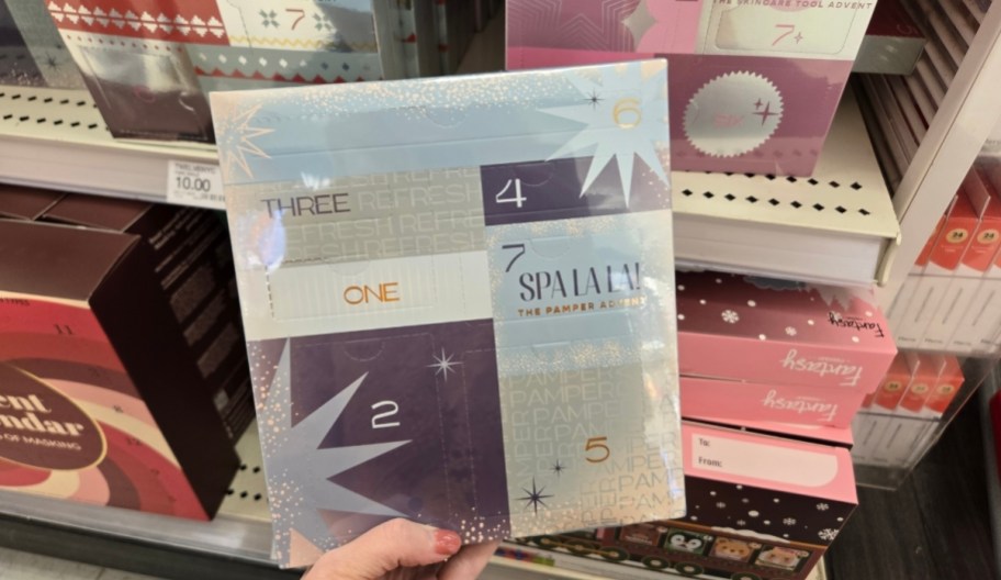 womans hand holding a advent calendar spa gift set