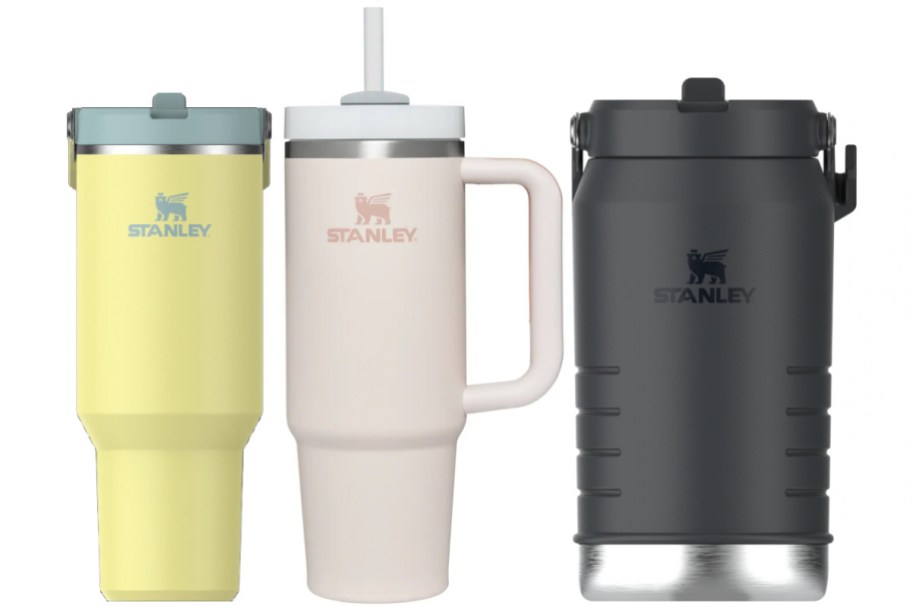 Yellow and pink Stanley tumblers and a black Stanley jug,