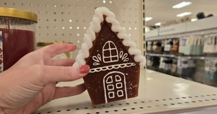 hand holding gingerbread candle in store