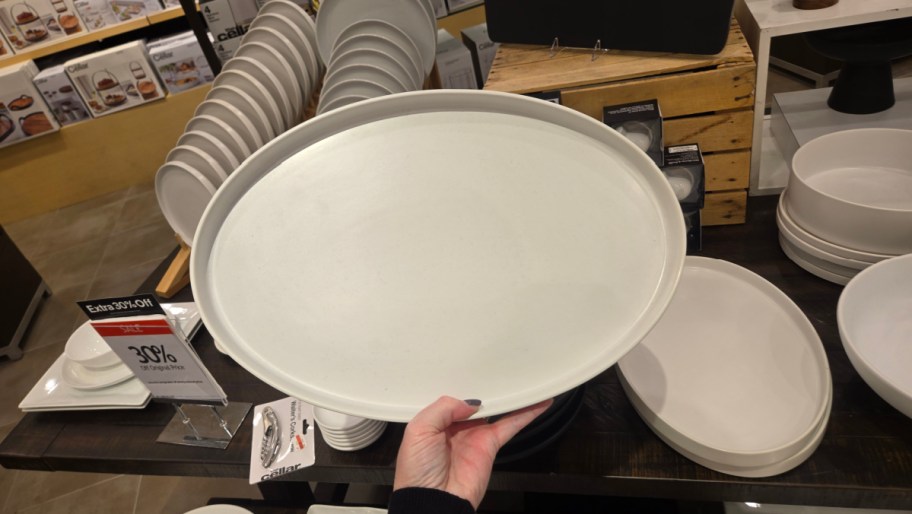 hand holding a platter in a store