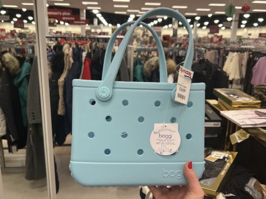 hand holding a blue bogg bitty bag