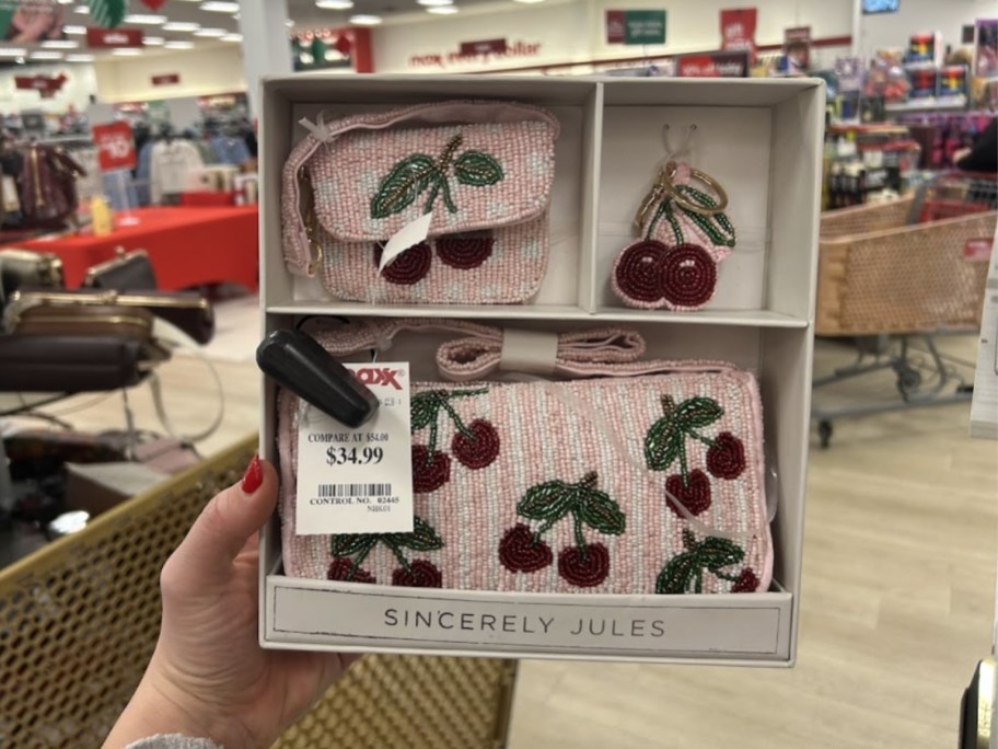 hand holding a box with a beaded cherry purse set
