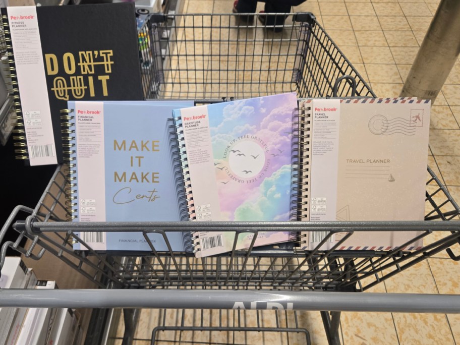 Four planners in a cart at Aldi.
