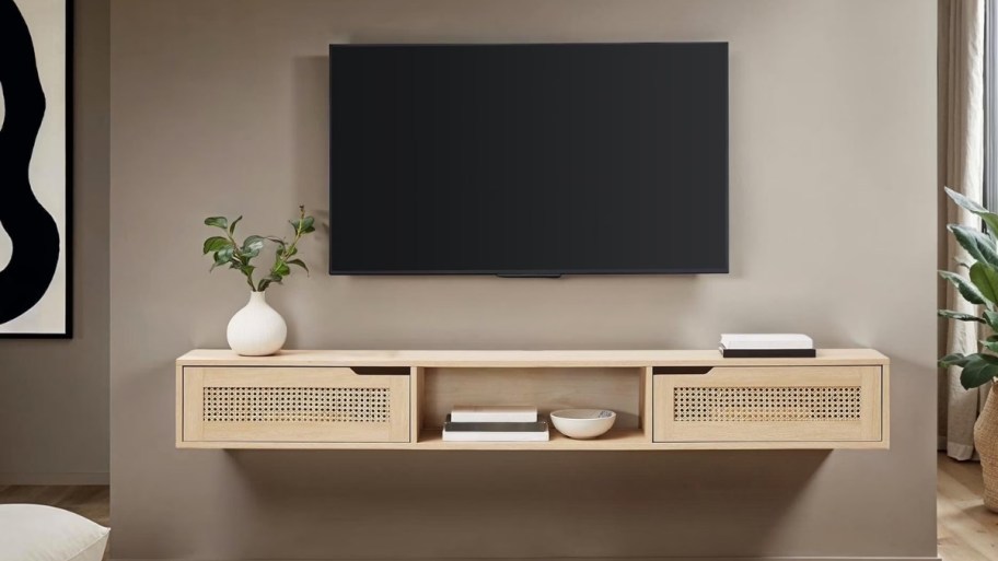 a floating tv console mounted on a wall