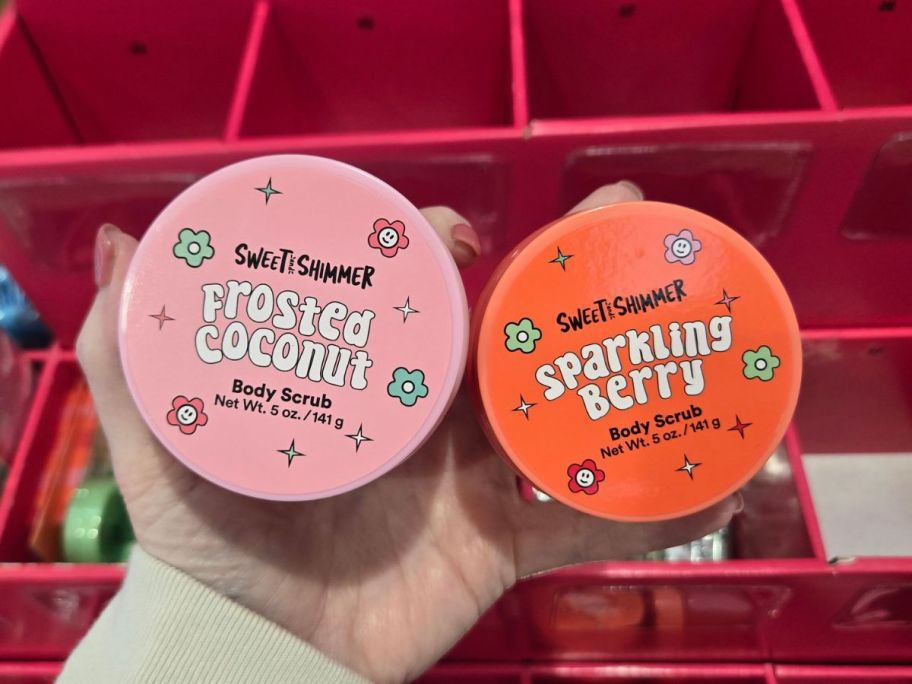 hand holding two sweet and shimmer stocking stuffers in store